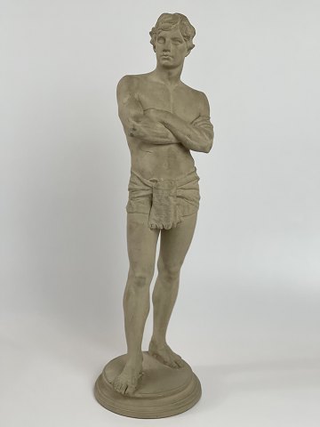 Antique terracotta figure of a standing man with loin cloth. The figure is stamped L. P. Jorgensen (Jørgensen), København (Copenhagen), Eneret (exclusive right). Circa 1890s.