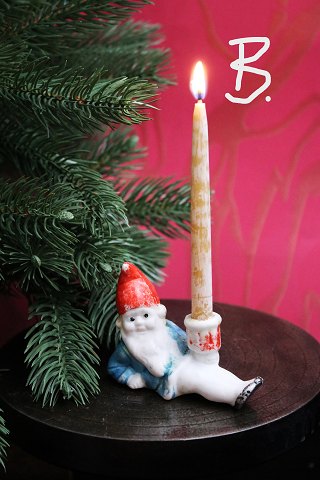 Old Christmas candlestick in  bisque of Santa Claus lying down holding a small 
Christmas candle...