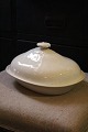 Old oval dish in cream colored earthenware with fine patina...