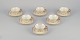 A set of six KP, Karlskrona tea cups with saucers in cream-colored porcelain 
with gold decoration.