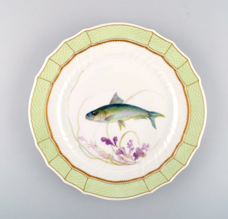 Royal Copenhagen fish plate with green edge, gold decoration and fish motif. Model 919/1710.