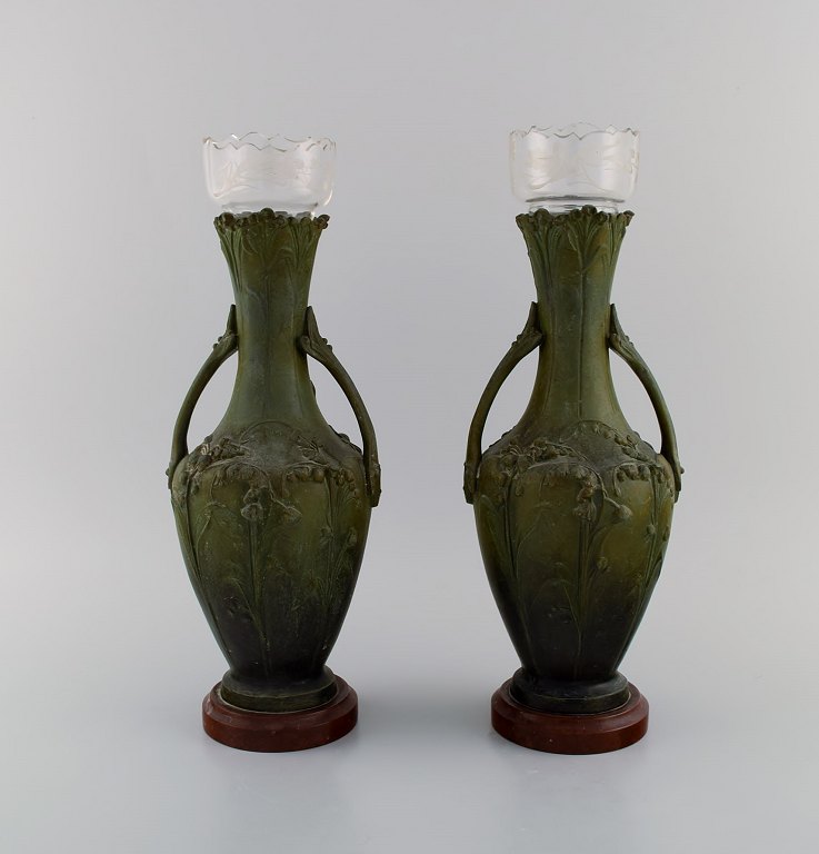 Hippolyte François Moreau (1832-1927), French sculptor. A pair of antique art nouveau vases with handles in green patinated bronze. Glass inserts. 1880s.