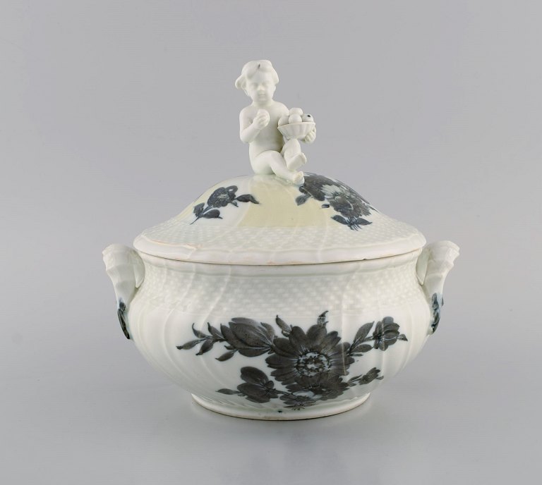 Early Royal Copenhagen Blue Flower Curved lidded tureen in porcelain with hand-painted flowers. Lid modeled with fruit-eating putti. Approx. 1820