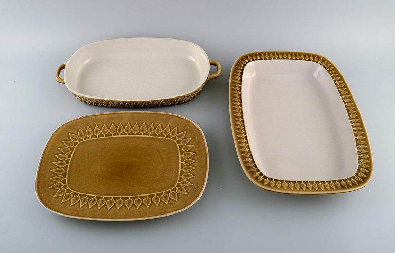 Jens H. Quistgaard (1919-2008) for Bing & Grøndahl. Three Relief serving dishes in glazed stoneware. Beautiful glaze in mustard yellow shades. 1960s.