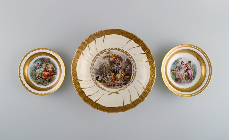 Three Royal Copenhagen bowls decorated with flowers and romantic scenery. Gold decoration. Mid-20th century.