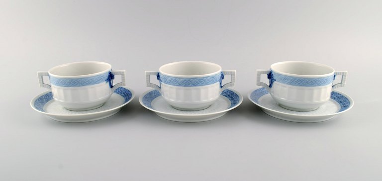 Three Royal Copenhagen Blue Fan bouillon cups with saucers. Designed by Arnold Krog in 1909.