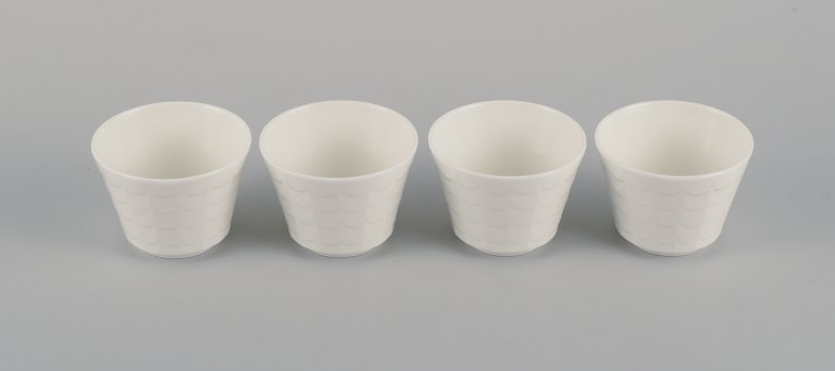 Wilhelm Kåge for Gustavsberg. Four flower pot covers in porcelain. Swedish design, 1960s.