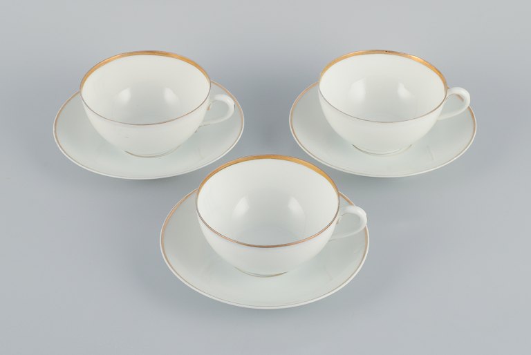 Rosenthal, Germany, a set of three large teacups and matching porcelain saucers. Thin white porcelain with gold decoration.