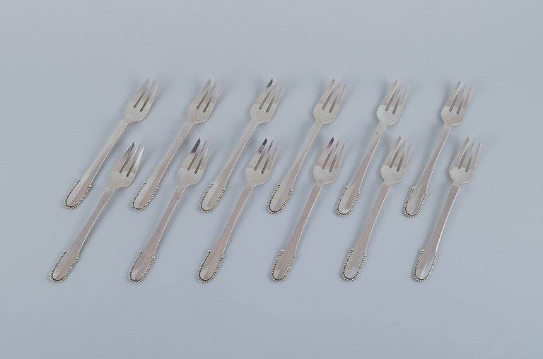 Georg Jensen Beaded.A set of twelve cake forks in sterling silver.