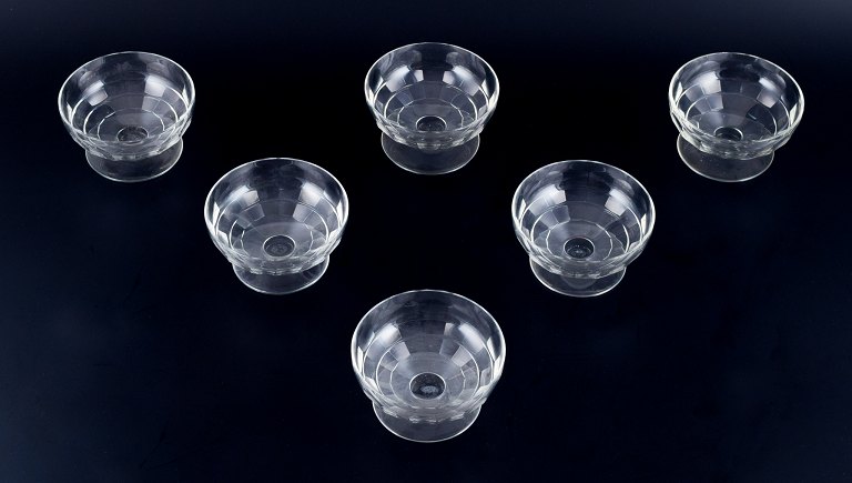 Baccarat, France, a set of six "Charmes" Art Deco champagne coupes in clear crystal glass. Faceted cut.
