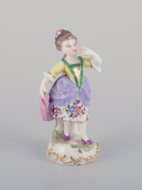 Antique German porcelain figurine. Young woman in elegant attire. Hand-painted in polychrome colors.