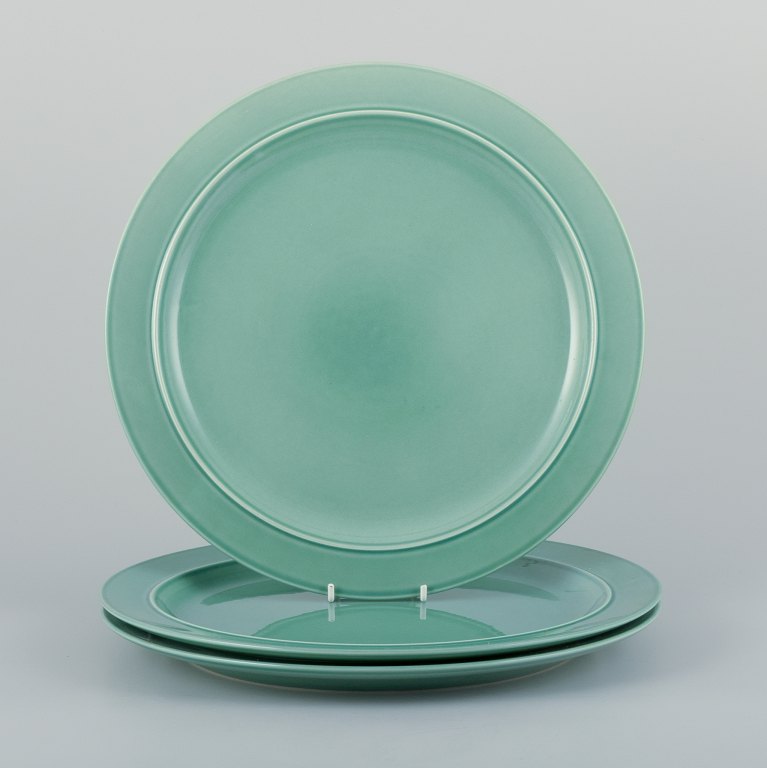 Royal Copenhagen, "4 All Seasons". A set of three dinner plates in faience with green glaze.