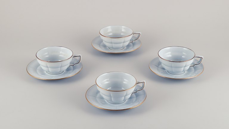 Gefle, Sweden, a set of four "Grand" Art Deco teacups with matching saucers. Light blue faience with gold trim.
