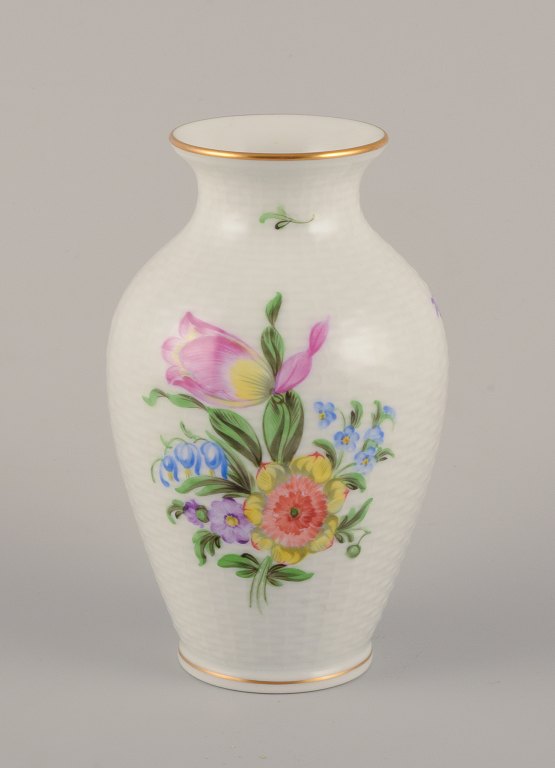 Herend, Hungary. Porcelain vase hand-painted with polychrome flower motifs and gold edge.