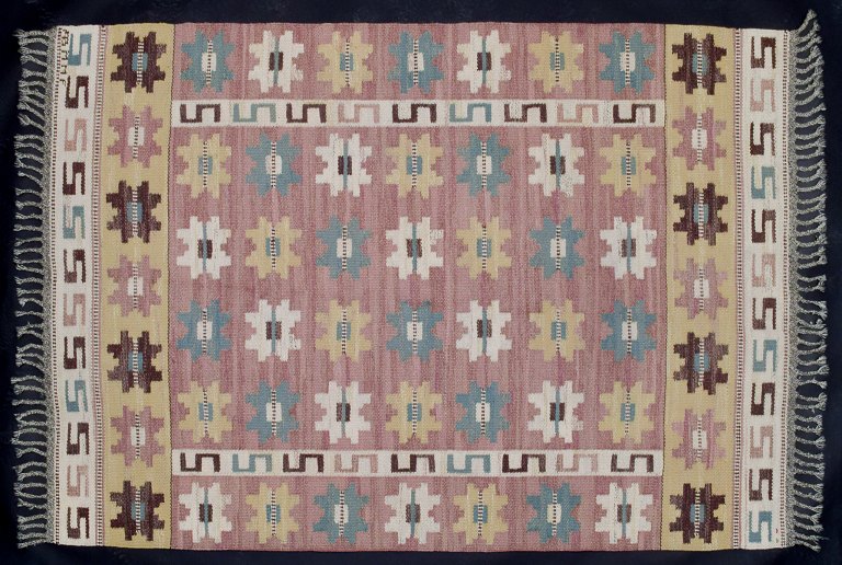 Märta Måås-Fjetterström (1873–1941), Swedish textile designer.“Sipporna” (The Anemones). Handwoven unique wool carpet in "rölakan" technique with polychrome geometric pattern.