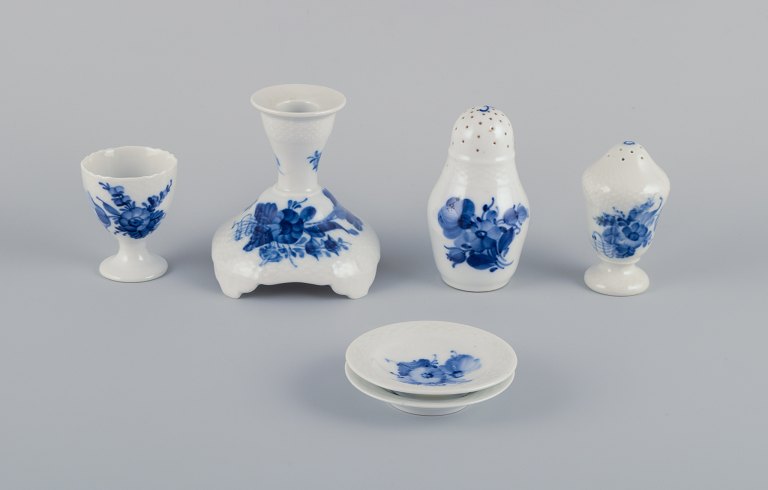 Royal Copenhagen Blue Flower Braided. Six pieces including a candlestick, egg cup, pepper shaker, salt shaker, and two butter dishes.Various dating.