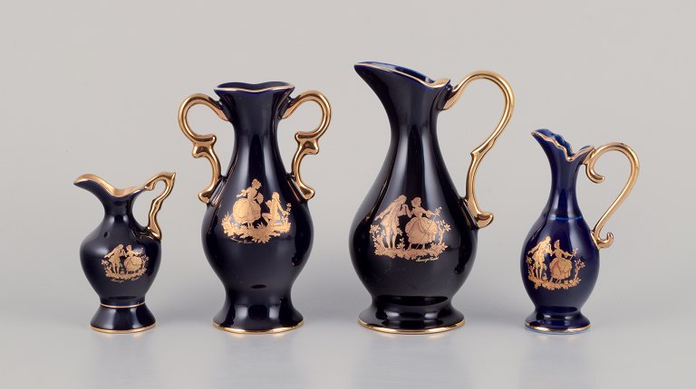 Limoges, France. Three pitchers and a vase in porcelain decorated with 22-karat gold leaf. Beautiful royal blue glaze. Scène galante.