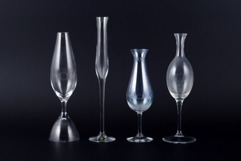 Kosta Boda and several other Swedish glassworks. Set of four tall mouth-blown glasses.
