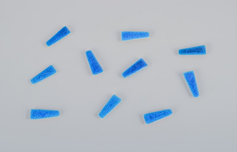 Ole Bjørn Krüger (1922-2007), Danish sculptor and ceramicist.Ten unique brooches in glazed stoneware in blue shades.