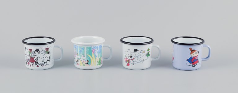 Muurla, Finland. Four enamel mugs with different motifs from the Moomin troll universe.