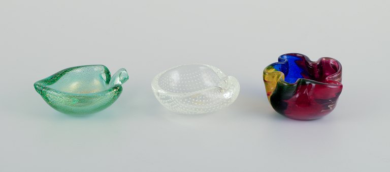 Three Murano art glass bowls.Polychrome glass, clear glass with bubbles, and green glass with gold dust.