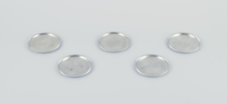 Just Andersen, a set of five pewter glass trays.