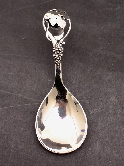 Silver serving spoon with grape motif