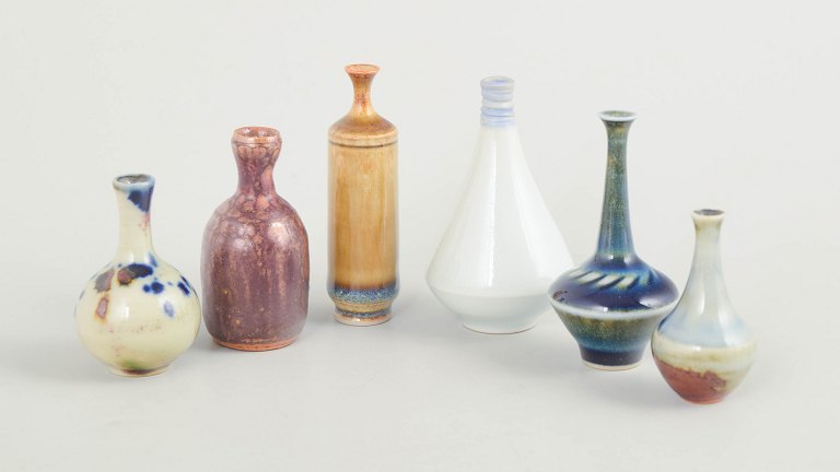Set of six miniature ceramic vases.