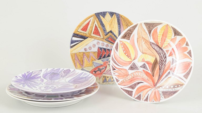 Set of five hand painted porcelain plates.